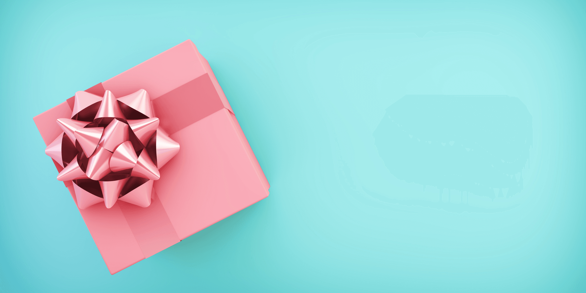 Pink gift box with a bow on a teal background