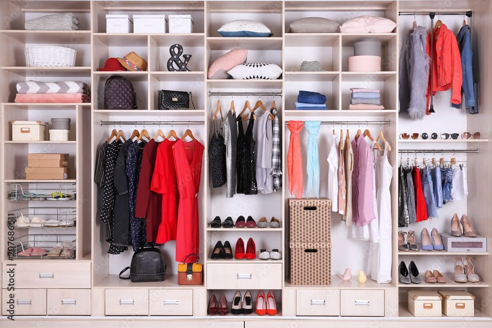 Large organized wardrobe with colour-sorted clothing and shoes