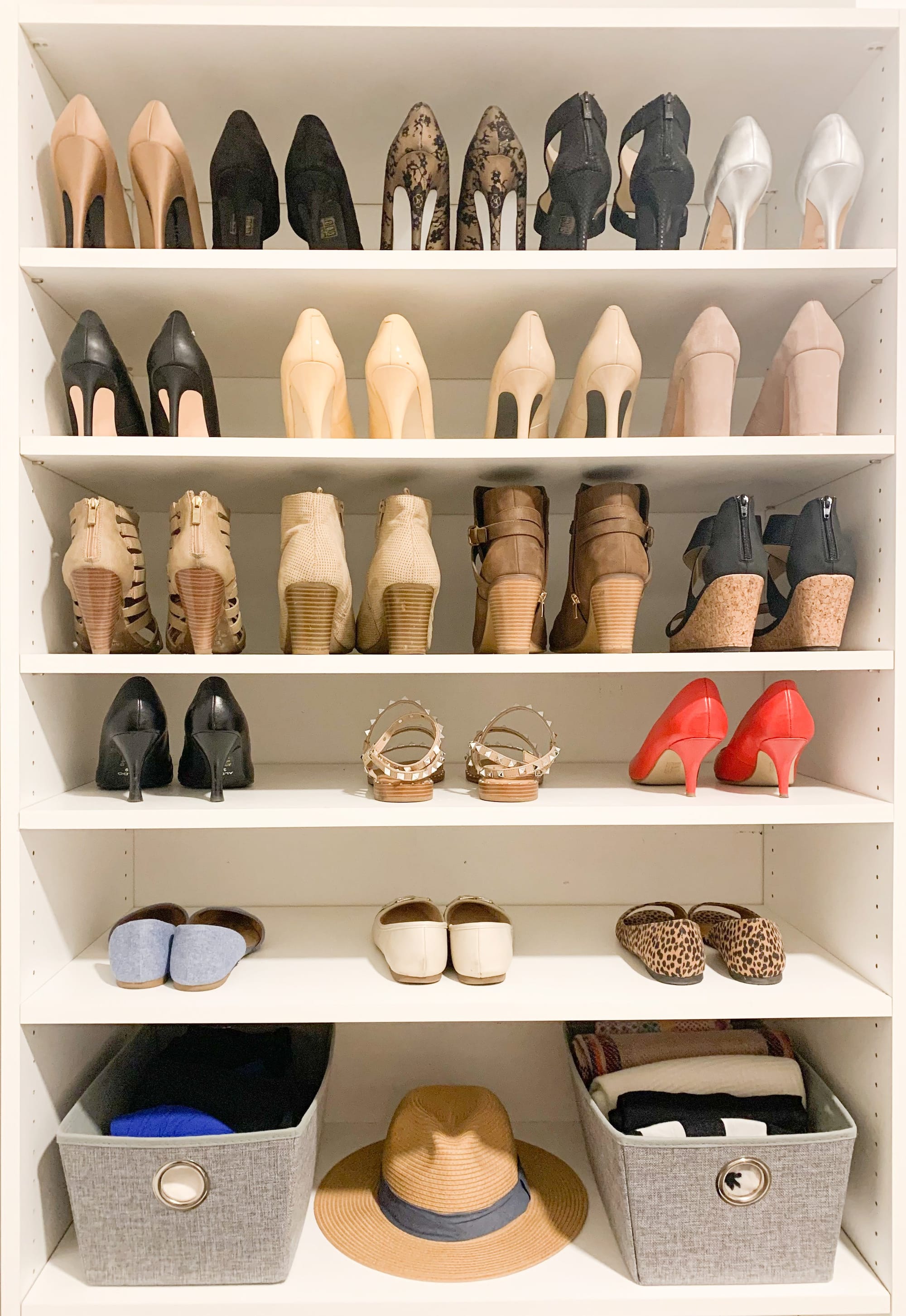 Closet shelves neatly arranged with heels, flats and storage bins