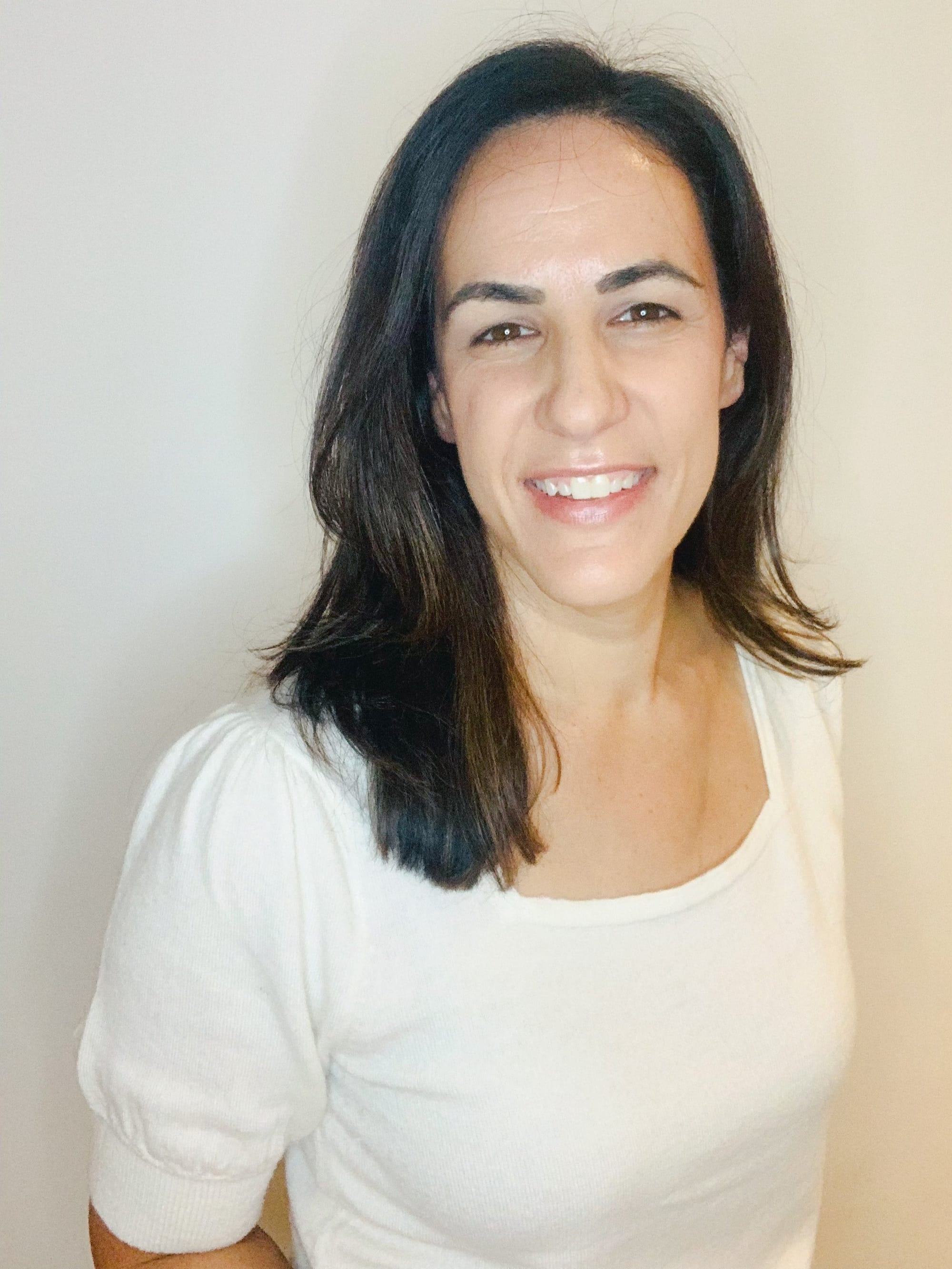 Smiling home organizer Stephanie in a white top